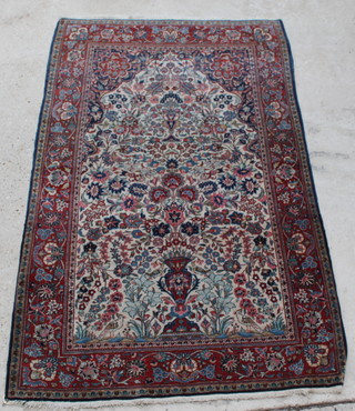 A Persian blue and red ground Kashan rug with mihrab and vase of flowers 82 1/2" x 54" 