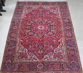 A red and blue ground Persian Heriz carpet with central medallion 147" x 108" 