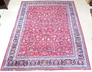 A red and blue ground Persian Meshad carpet with floral design, signed, 155" x 119", some wear 