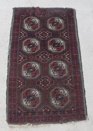 A red and blue ground Afghan rug with 8 octagons to the centre 69" x 37" 