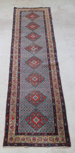 A Persian Shirvan blue and brown ground runner with 8 octagons to the centre within multi-row borders 140" x 37" 