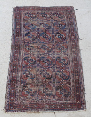 An Afghan red and blue ground rug with 21 octagons to the centre within a multi row border 72" x 41"