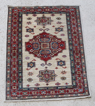 A white ground Caucasian style rug with central medallion within multi row borders 46 1/2" x 34 1/2" 