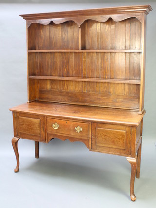 A Georgian style oak dresser the raised back with moulded cornice, shaped apron and fitted 2 shelves, the base fitted 1 long drawer flanked by a pair of cupboards, raised on cabriole supports 78"h x 60"w x 21 1/2"d 