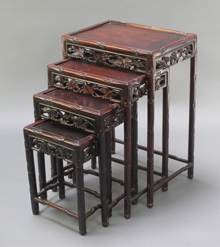 A harlequin nest of 4 Chinese rectangular hardwood interfitting coffee tables (made up of 2 different pairs) with pierced aprons, 28"h x 19"w x 14"d, 24"h x 12"w x 17"d, 20"h x 14"w x 10"d and 15"h x 12"w x 8"d 