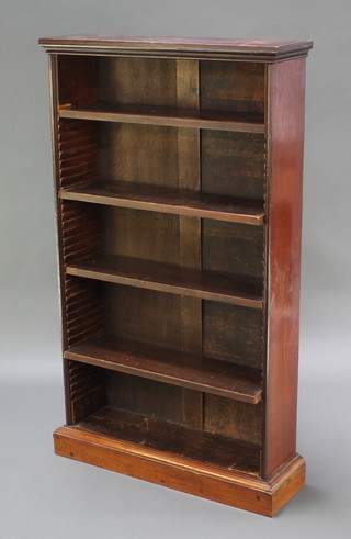 A Victorian mahogany bookcase fitted adjustable shelves, raised on a platform base 48"h x 28"w x 7 1/2"d 