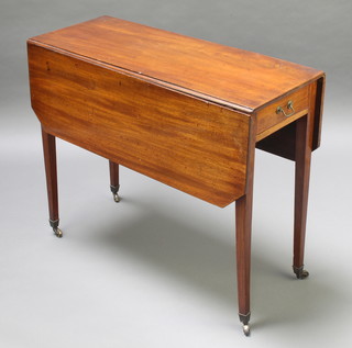 A 19th Century rectangular mahogany drop flap dining table fitted a frieze drawer and raised on square tapering supports, brass caps and casters 29"h x 35"w x 14 1/2" when closed by 38 when open 
