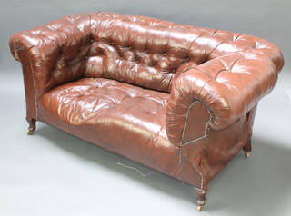 A 2 seat drop arm Chesterfield upholstered in brown buttoned leather, raised on cabriole supports 30"h x 67"l x 34"d 