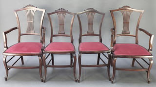A set of 4 Edwardian mahogany dining chairs with carved cresting rails and pierced vase shaped slat backs, raised on cabriole supports (2 carvers, 2 standard)