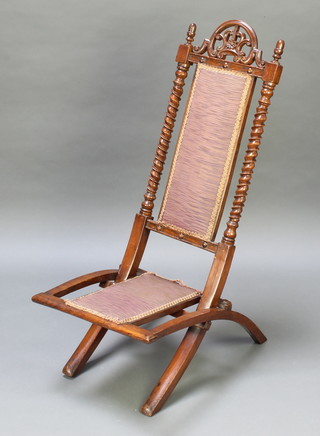 A Victorian mahogany folding chair with spiral turned columns to the sides, pierced cresting rail, the back and seat formerly woven cane and now upholstered