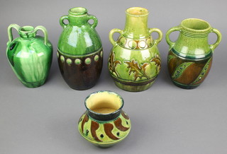 A Studio Pottery green glazed tapered 2 handled vase 8", a baluster ditto 10" and an oviform ditto with stylised leaf decoration 10", another with spiral decoration 8 1/2" and a squat vase with symetrical decoration 5" 