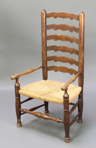 An elm Lancashire ladder back chair with woven rush seat, raised on turned supports 