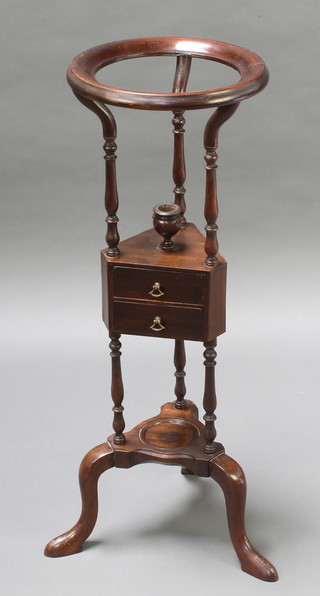A Georgian style circular mahogany wash stand fitted a bowl receptacle, the base fitted 2 short drawers above a triform base, raised on scroll feet 34"h x 12" diam. 