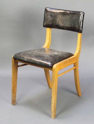 A mid 20th Century beech framed bar back chair, the seat and back upholstered in black leather