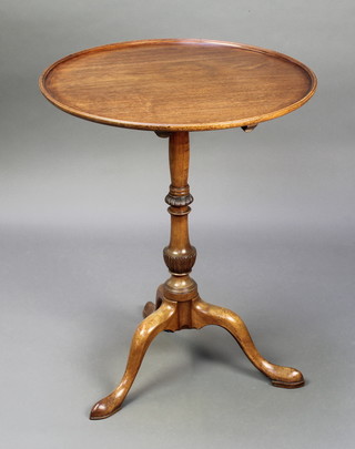 A Georgian style circular mahogany snap top tea table, raised on turned column and tripod base 29"h x 23"diam. 