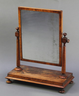 A 19th Century rectangular plate dressing table mirror contained in a mahogany swing frame, raised on bun feet 26"h x 21"w x 10"d 