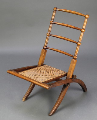 A Victorian mahogany ladder back campaign style chair with woven rush seat 