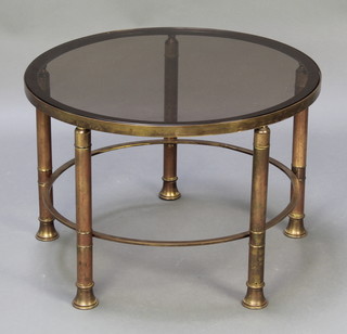 A circular gilt metal coffee table with plate glass top, raised on 5 gilt columns 16 1/2" x 24" diam. 