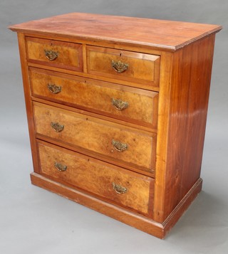An Edwardian figured walnut chest of 2 short and 3 long drawers with brass drop handles, raised on a platform base 36" x 35 1/2" x 20 1/2" 