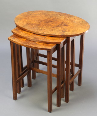 A nest of 3 Art Deco figured walnut interfitting coffee tables raised on square tapering supports 21"h x 22"w x 15"d, 20"h x 15"w x 13 1/2"d, 19 1/2"h x 13"w x 11 1/2"d