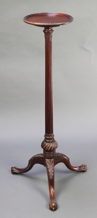 An Edwardian, Georgian style mahogany torchere with circular top, raised on a turned and fluted column with pillar and tripod supports, egg and claw feet 39"h x 10" diam. 