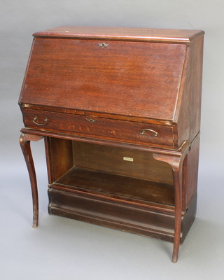 An oak Globe Wernicke bureau, the fall front revealing a fitted interior above 1 long drawer, the base fitted a bookcase (no door), raised on a platform base fitted cabriole legs to the front  44"h x 34"w x 19"d  
