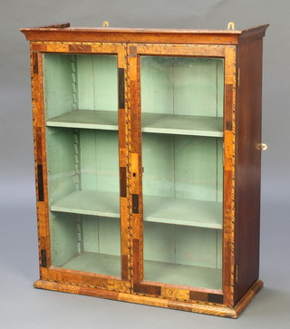 A 19th Century mahogany hanging display cabinet with moulded cornice, the interior fitted adjustable shelves enclosed by a pair of glazed panelled doors inlaid specimen veneers 32"h x 27"w x 11"d 