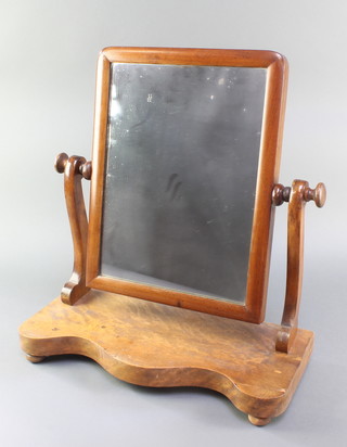 A Victorian rectangular mahogany plate dressing table mirror in a swing frame, the base of serpentine outline 21 1/2"h x 20"w x 9"d 