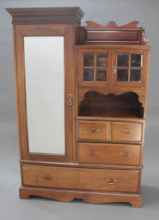 A Victorian mahogany single combination wardrobe with moulded and dentil cornice above a cupboard enclosed by a bevelled plate mirrored door flanked by a cupboard enclosed by 2 glazed panelled doors above a recess with 2 short and 1 long drawer, the base fitted 1 long drawer 92"h x 43"w x 19"d 
 