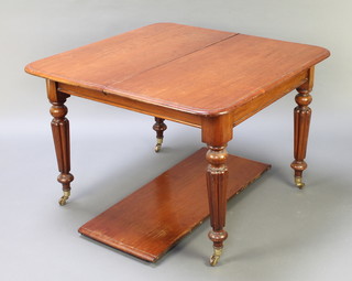 A Victorian mahogany extending dining table with 1 extra leaf, raised on turned and reeded supports with brass caps and casters 28"h x 41"w x 42"l x 59" when extended 