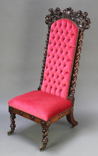 A Victorian carved rosewood show frame nursing chair upholstered in red button back material, raised on spiral turned supports (frame loose) 