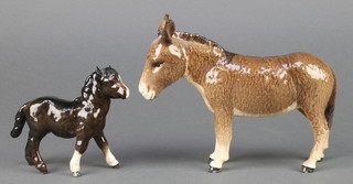 A Beswick figure Donkey, brown gloss, 2267A 5 1/2" and a ditto foal with right turned head, black gloss, 4 " 