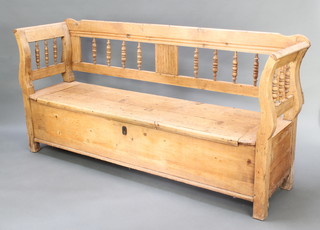 A 19th Century Continental stripped and polished pine settle with hinged lid and bobbin turned decoration 36"h x 76"w x 19"d 