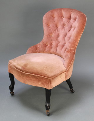 A Victorian nursing chair upholstered in pink buttoned dralon on cabriole supports (frame loose)