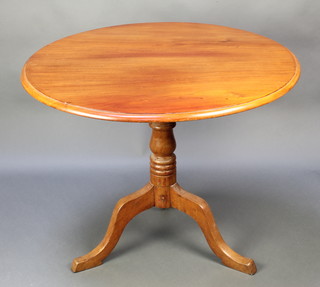 A 19th Century circular snap top tea table, raised on turned column and tripod base 27"h x 35" diam. 

