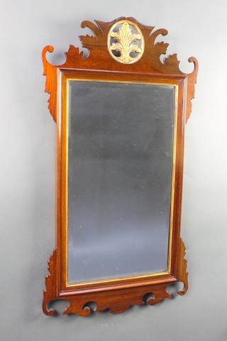 A Chippendale style bevelled plate wall mirror contained in a carved walnut frame 34" x 18 1/2"