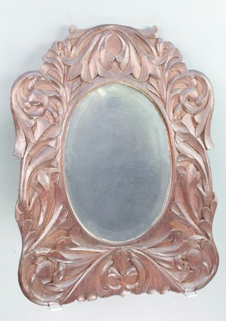 A 19th Century Continental oval bevelled plate wall mirror contained in a carved mahogany frame 22"h x 16 1/2"w 
