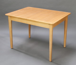 Gordon Russell, a 1950's light oak extending dining table, raised on square tapering supports with 1 extra leaf, 30"h x 31"w x 42 1/2" x 60" when extended  