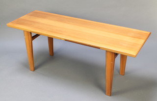 A mid 20th Century rectangular polished teak coffee table, the base fitted 2 double sided formica slides, raised on square tapered supports, the base marked WR, 21 1/2"h x 55"w x 19 1/2"d 
