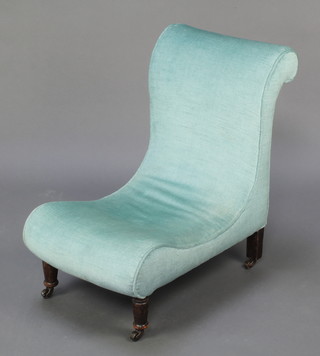 A Victorian nursing chair upholstered in light blue material 