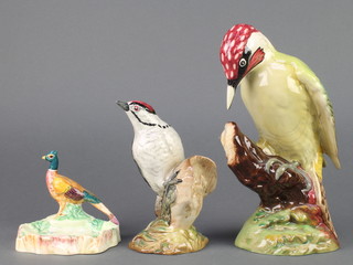 A Beswick figure Woodpecker on branch 1218 9 1/2", a ditto of a Lesser Spotted Woodpecker 2420 6" and a pheasant 3" 