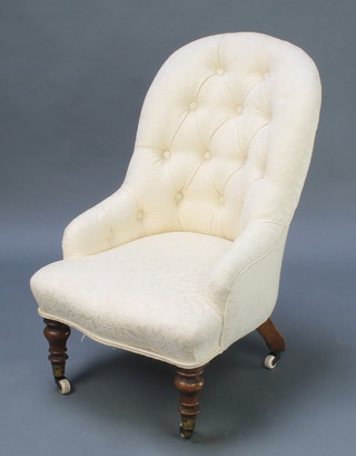 A Victorian iron framed tub back chair upholstered in white material, raised on turned supports