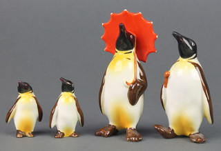 A Beswick figure Penguin with umbrella 802 4 1/2", a ditto holding an umbrella 803 4", 2 smaller ditto with right turned head 2"
