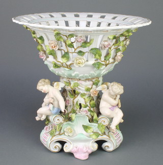 A Potschappel centrepiece, the pierced bowl with flowers, the base with 3 seated cherubs 12"