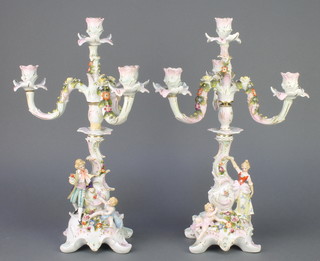 A pair of Potschappel 4 light candelabra encrusted with flowers, the base with lady and gentleman with cherubs 16" 