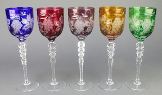 Five cut glass coloured hocks with vinous decoration 8"
