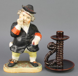 A Victorian Staffordshire jug in the form of a snuff taker 13" together with a French glazed chamberstick 8" 