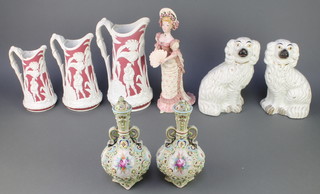 A set of 3 Victorian 2 colour graduated jugs decorated with figures in jungle setting 12", 10" and 8", a pair of Staffordshire white glazed Spaniels 10", a pair of Continental 2 handled vases and covers with floral decoration 8" and a figure of an Edwardian lady by Kathleen fisher 1976 12" 