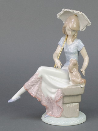 A Lladro Society figure "Picture Perfect" girl with parasol and puppy 7612 8 1/2", boxed