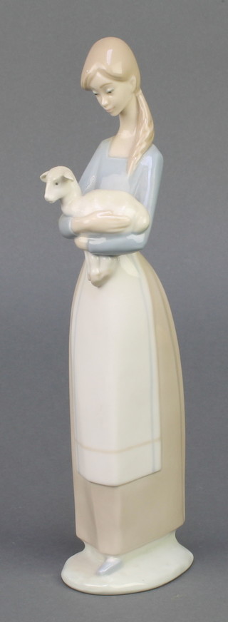 A Lladro figure of a lady holding a lamb 10" 